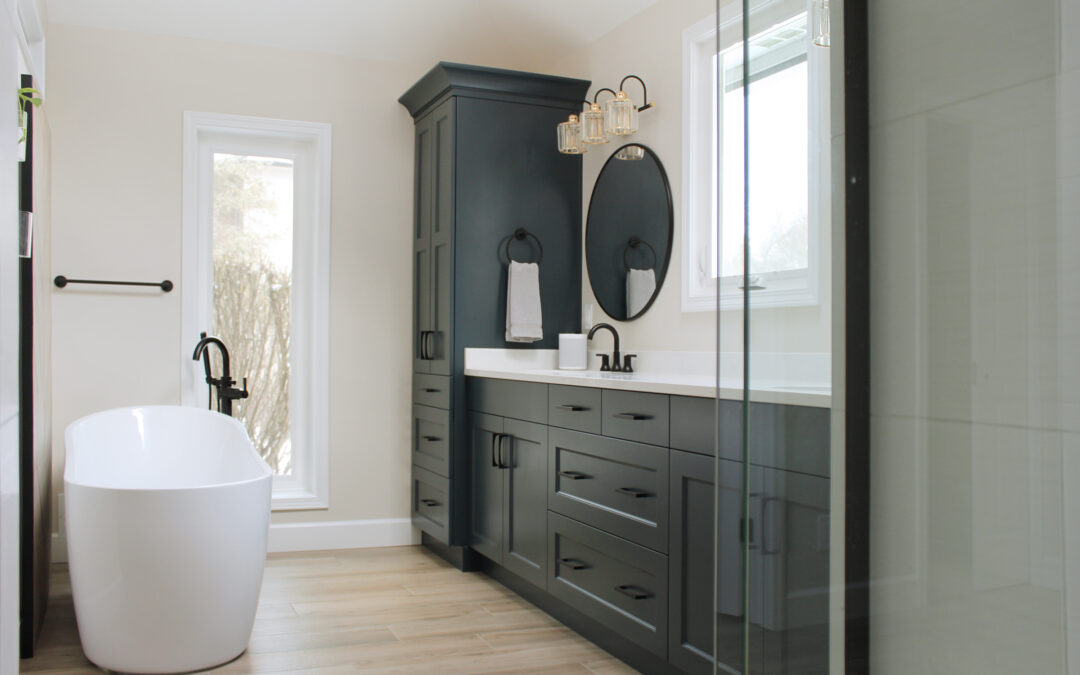 Spa-Like Luxurious Bathroom Remodel with white soaking tub and modern dark grey vanity and storage cabinets